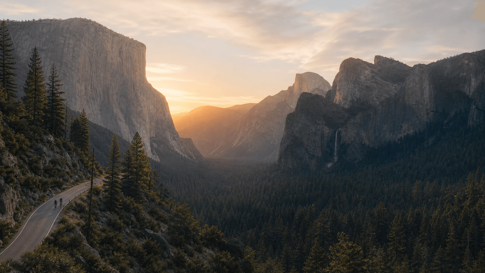 Two cyclists riding above Yosemite Valley in the last golden light